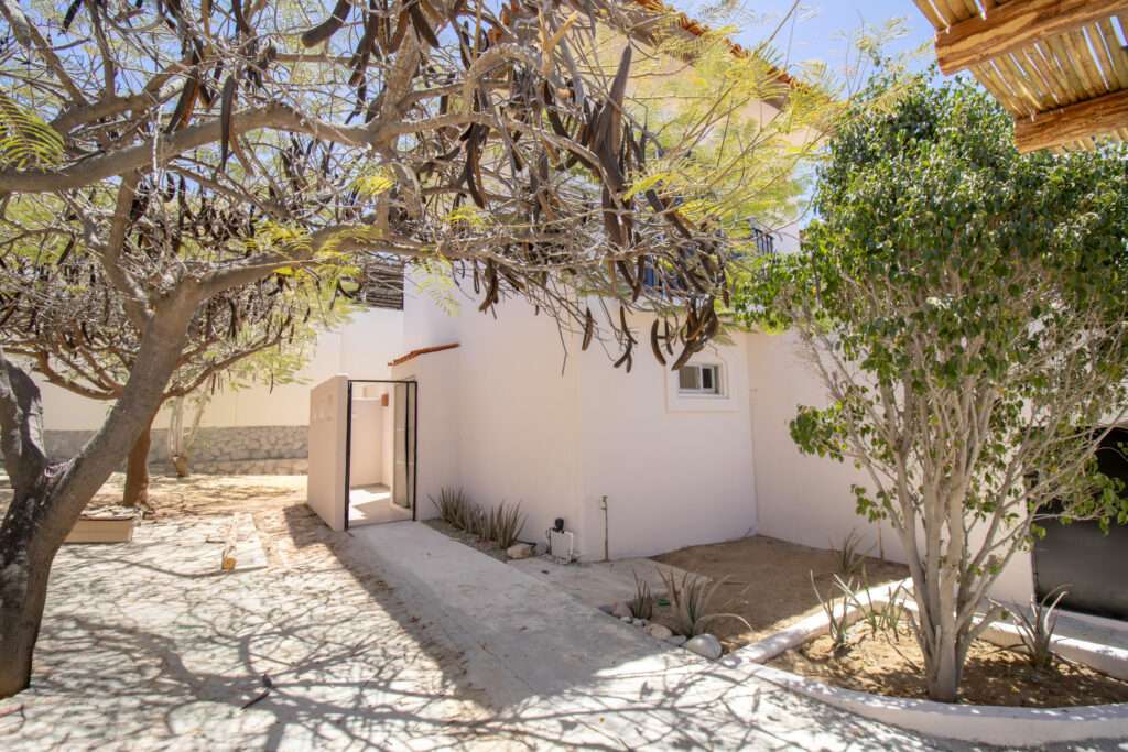 Cabo del Sol El Posito We are excited to introduce Casa Elisabeth, an amazing, newly constructed custom home in the private El Posito area of Todos Santos. Located just three rows back from the beach, this three-bedroom, three-full and two-half bathroom residence offers every amenity desired for a tropical paradise. The downstairs features an open-concept living room, dining room, and a fully stocked kitchen with brand-new appliances, including a dishwasher. The main floor also includes a laundry room and an outdoor water feature with a professionally designed rock wall. The principal bedroom downstairs offers a unique indoor/outdoor bathroom with two showers and an outdoor bathtub.Each of the three bedrooms includes an en-suite bathroom with double vanities. The upstairs bedroom features its own private furnished terrace and access to one of four large patios, complete with a bar area and outdoor furniture perfect for enjoying ocean sunsets. Additionally, a shaded third-floor observation deck provides panoramic ocean and mountain – 31 Callejon del Arco, Cabo Corridor, BS