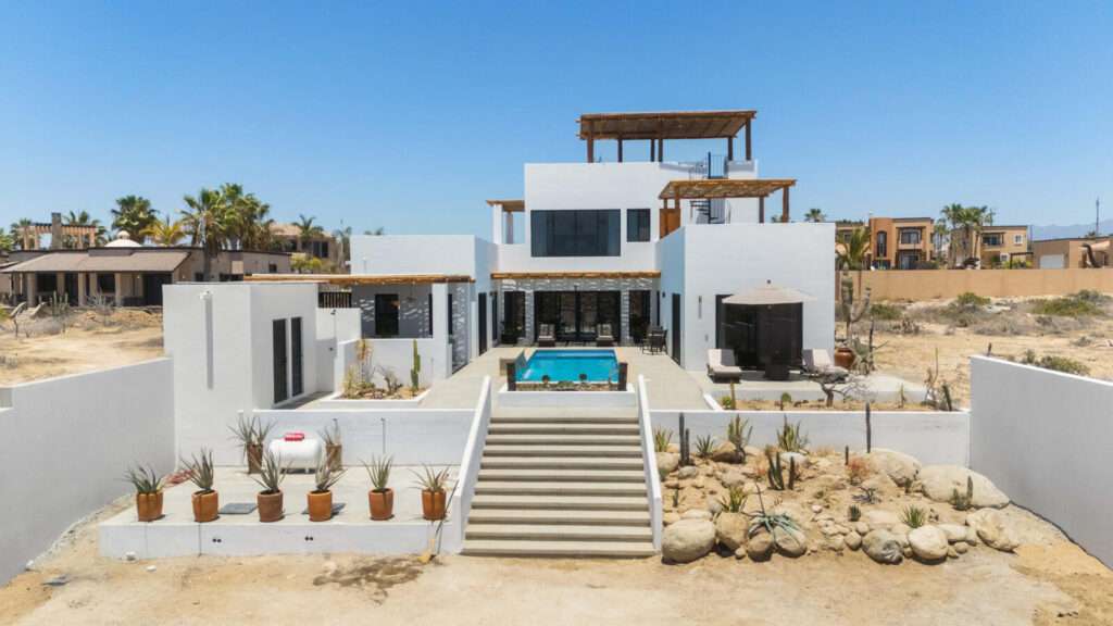 Cabo del Sol El Posito We are excited to introduce Casa Elisabeth, an amazing, newly constructed custom home in the private El Posito area of Todos Santos. Located just three rows back from the beach, this three-bedroom, three-full and two-half bathroom residence offers every amenity desired for a tropical paradise. The downstairs features an open-concept living room, dining room, and a fully stocked kitchen with brand-new appliances, including a dishwasher. The main floor also includes a laundry room and an outdoor water feature with a professionally designed rock wall. The principal bedroom downstairs offers a unique indoor/outdoor bathroom with two showers and an outdoor bathtub.Each of the three bedrooms includes an en-suite bathroom with double vanities. The upstairs bedroom features its own private furnished terrace and access to one of four large patios, complete with a bar area and outdoor furniture perfect for enjoying ocean sunsets. Additionally, a shaded third-floor observation deck provides panoramic ocean and mountain – Casa Elisabeth, Pacific, Pacific, BS